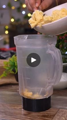 a blender filled with food on top of a wooden table