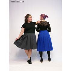 two women standing next to each other in front of a white background wearing black and blue skirts