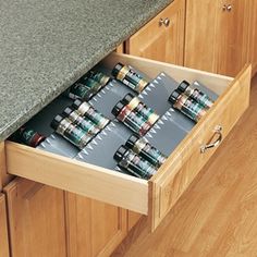 an open drawer in a kitchen filled with cans