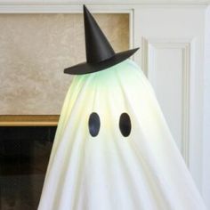 a white ghost with a black hat on it's head