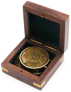 an open wooden box with a compass inside