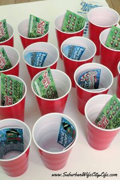 red cups filled with candy sitting on top of a table