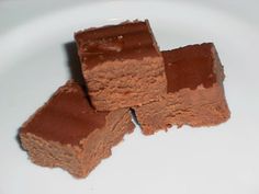 three pieces of brownie sitting on top of a white plate