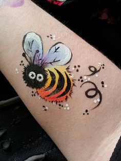 a tattoo with a bee painted on it