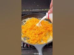 someone is pouring cheese into a skillet