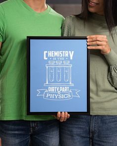 two people holding up a blue poster that says chemistry is the dirty part of physics