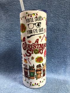 a christmas story tumbler cup with a straw sticking out of it's lid