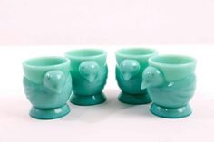 four green glass cups with elephants on them