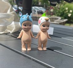 two small toy animals standing next to each other