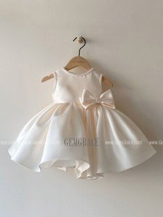 a white dress hanging on a wall