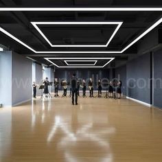 a group of people standing in an empty room