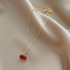 Enhance any outfit with this beautiful Wine Red Cherry Gold Pendant Necklace. Featuring a classic design and bold red hues, it will make a stunning fashion statement that will be admired by all. This statement piece is perfect for your collection. Red Ruby Round Necklaces, Elegant Cherry Colored Jewelry For Party, Red Round Necklace For Her, Red Round Jewelry, Red Clavicle Chain Necklace For Party, Elegant Red Necklace With Clavicle Chain, Red Ruby Jewelry Gift For Her, Elegant Red Clavicle Chain Jewelry, Elegant Red Clavicle Chain Necklace