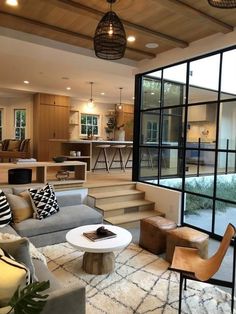 a living room filled with furniture and lots of windows