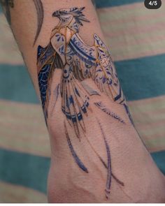 a person's arm with tattoos on it and a bird flying in the air