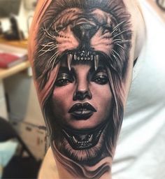 a woman with a lion head tattoo on her arm