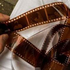 a film strip being held up by someone's hand