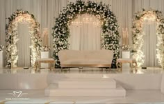 an elegant wedding setup with white flowers and greenery