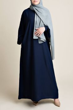 Model wearing a classic Abaya with side pockets in a navy blue color - Front pose - Momina Hijabs Color Abaya Design, Navy Blue Abaya, Straight Abaya, Everyday Abaya, Blue Abaya, Modest Woman, Hijab Colors, Abaya Outfit, Blue Color Combinations