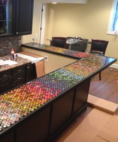 a kitchen filled with lots of soda cans on top of a counter next to a sink