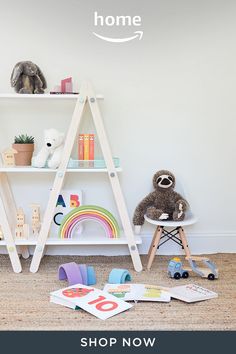 a white shelf with books and toys on it in a child's playroom