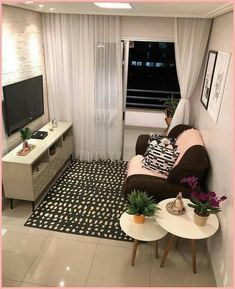 a living room filled with furniture and a flat screen tv sitting on top of a wall