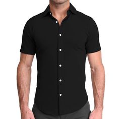 A true athletic fit short sleeve button down crafted from a cotton-spandex blend, this black short sleeve is as soft and stretchy as it gets. "The Roth" is the most versatile button down for in all seasons, featuring shortened length and a curved hemline, leaving you looking and feeling fresh for both casual wear and a great night out. Care: Machine wash cold. Hang to dry. Fabric: 90.5% Cotton / 9.5% Spandex Model is 6' and 185 lbs. filling out size Medium. SIZING Our shirts are designed for a " Classic Black Stretch Shirt, Black Cotton Short Sleeve Shirt With Buttons, Classic Stretch Short Sleeve Shirt, Classic Fitted Short Sleeve Button-up Shirt, Fitted Classic Short Sleeve Button-up Shirt, Classic Fitted Short Sleeve Shirt With Buttons, Fitted Classic Short Sleeve Shirt With Buttons, Black Cotton Button-up Short Sleeve Shirt, Fitted Classic Short Sleeve Shirt