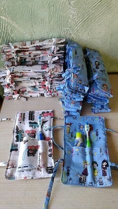 several pieces of cloth sitting on top of a wooden table next to a toothbrush