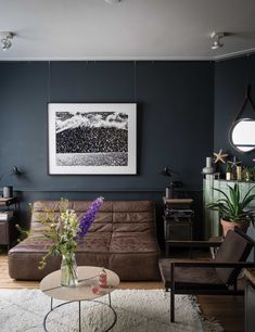 a living room filled with furniture and a painting on the wall