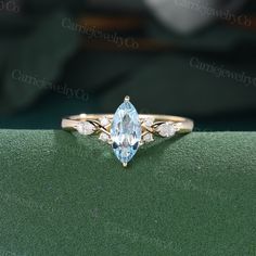 an engagement ring with a pear shaped blue topazte