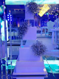 a three tiered white cake sitting on top of a table