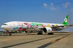 an airplane with hello kitty painted on it's side sitting on the tarmac