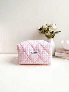 Our pink gingham makeup bag is handmade using cotton fabric and cotton lining. It offers function and style and fits perfectly in your tote bag, weekender, carry on or check in luggage to carry all your essentials while on the go.  We recommend using it for cosmetics, skincare, haircare, stationary and other accessories.  Featuring quilted pink gingham fabric, secure white zipper pull and a beige lining. Perfect for travel and everyday use. Dimensions of product  20cm width x 14cm height x 13cm Check In Luggage, Sac Week End, Small Sewing, Gingham Fabric, Small Sewing Projects, Cosmetics Bag, Cosmetics Skincare, Pink Gingham, Wash Bag