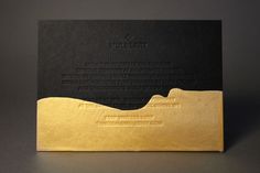 a black and gold business card sitting on top of a gray surface with the words tuttleberry printed on it