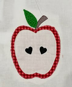 an apple appliqued on a piece of cloth