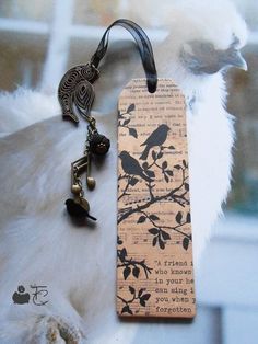 a bookmark with a bird on it and a keychain attached to it