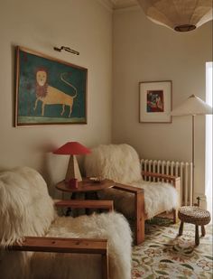 a living room filled with furniture and a painting on the wall