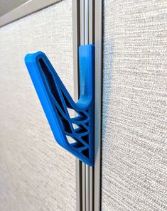 a close up of a blue plastic object on the side of a wall