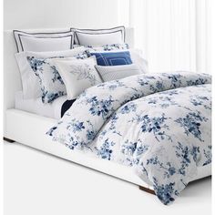 a bed with blue and white flowers on it