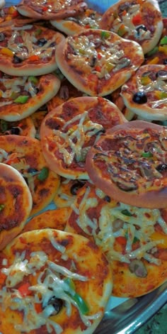 many different types of pizzas on a platter