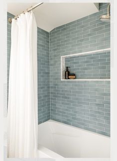 a white bath tub sitting next to a shower curtain