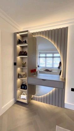 a room with shelves and purses on the wall next to a mirror in it