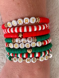 a stack of bracelets that say merry and bright on the front, with white beads