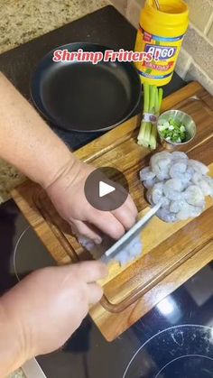 a person chopping onions on a cutting board with a knife in front of them