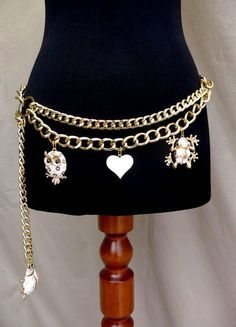 Gold Hand Made Double Swag Hip Chain Belt with an Enamel Owl, Heart, Frog & Ladybug Charms. Drape Shape Chain Belt features two chunky gold coloured curb link with double draping chains divided  by two big gold rings on either side, and adjustable clasp closure. A White and Gold enamel Heart which dangles from the middle the be is flanked on ether side of the chain by  a cute Gold & White enamel Owl (1"5)  Charm and a Gold & White enamel Frog (1"6)  The end of the chain is finished with a fab la Unique Belts, Big Gold Chains, Skz Concert, Hip Chain, Jewelry Belt, Hip Jewelry, Belly Belt, 2024 Jewelry, Dr Wardrobe