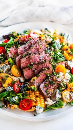 steak and corn salad on a white plate