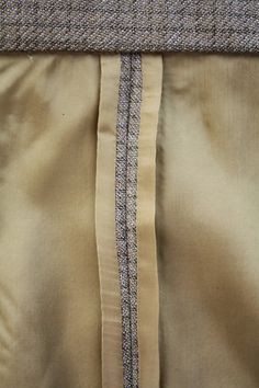 closeup of the side of a dress with buttons and lines on it's lapel