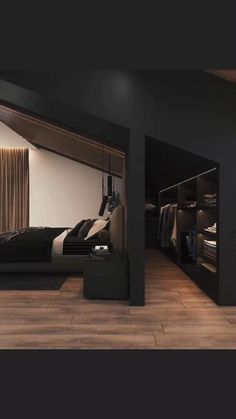 a bedroom with black walls and wooden flooring in the room is lit by recessed lighting