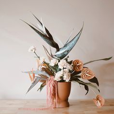 a vase filled with flowers on top of a wooden table