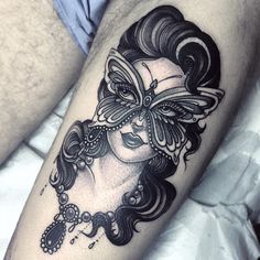 a woman's face with a butterfly tattoo on her arm and leg, in black and white