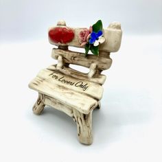 a small wooden chair with flowers on the seat that says, i'm loved only